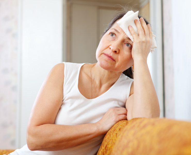 mature woman uses handkerchief on  head